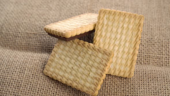 Three stacked shortbread cookies on a rustic rough sackcloth