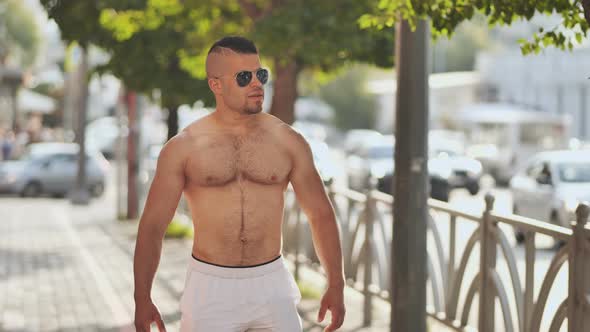 A Muscular Jordanian Man Walks Around the City Without a Shirt