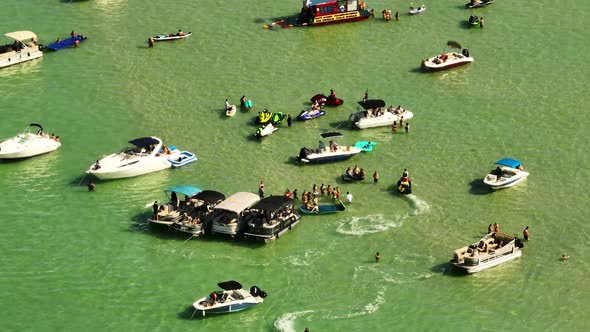 People at Haulover sandbar 4k 7x zoom aerial