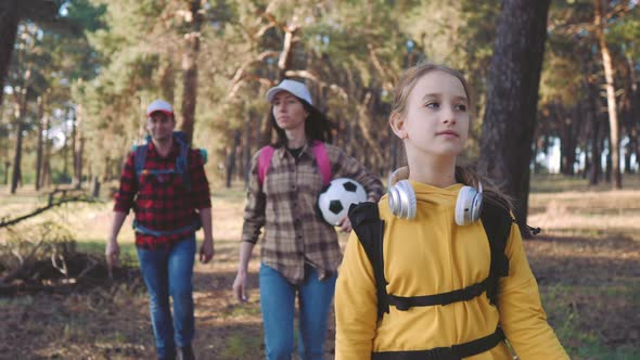 Happy Family Hiking Through a Forest