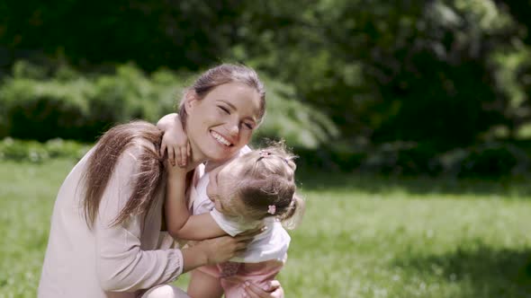 Happy Family. Woman And Kid Hugging And Kissing In Nature