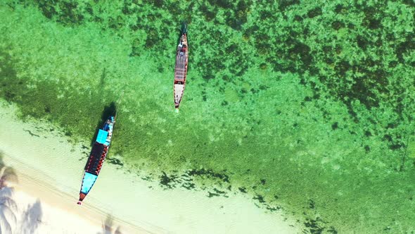 Aerial view scenery of marine coast beach trip by aqua blue ocean and white sand background of a day