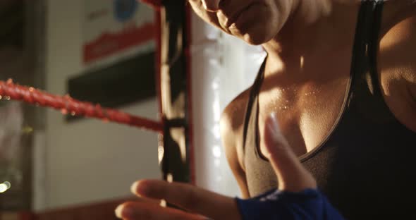 Female boxer wearing blue strap on wrist