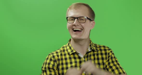 Caucasian Fashionable Man in Glasses Very Emotionally Celebrates Something