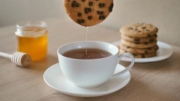 Hand Dipping Chocolate Chip Cookies in Tea