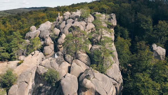 Wedding Couple in Mountain Rock From Drone. Aerial View Happy Newlyweds in Love Hugging Standing on