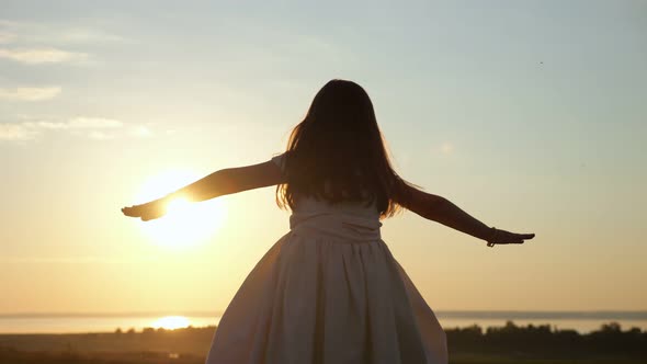 Preschooler Girl Walks on Meadow Imagining Herself As Bird