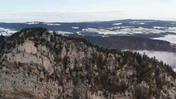 Aerial of high mountain top above the clouds