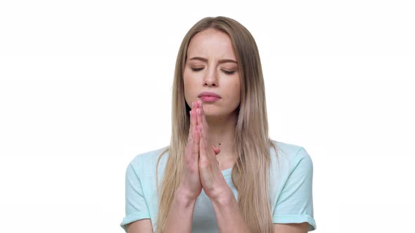 Portrait of Woman Looking Up with Keeping Hands in Praying Pose and Expressing Hope and Desire