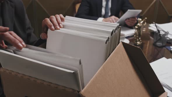 Female Lawyer Looking Over Files in Box