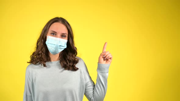 Attractive Curly Young Wearing Face Mask Isolated on Yellow