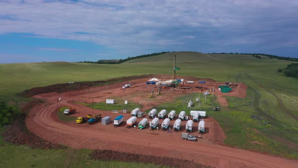 Oil and Gas a Land Rig Onshore Drilling Rig in the Middle of a Rice Field Aerial View From a Drone