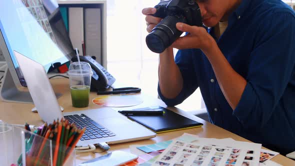 Male executive clicking a picture on digital camera 4k