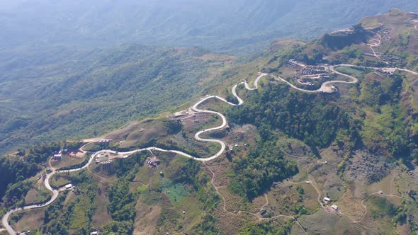 Aerial view of cars driving on curved, zigzag curve road or street on mountain hill