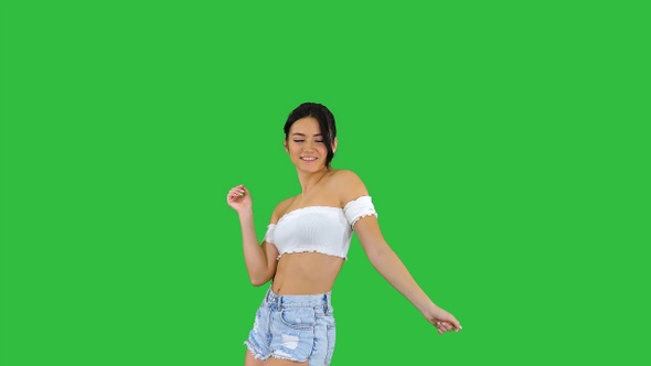 Beautiful Latin woman dancing on a Green Screen, Chroma Key.