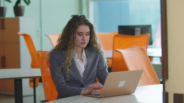 Overworked Tired Busy Woman Closing Laptop Leaning on Chair Sitting in Office Indoors