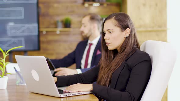 Young Businesswoman Typing on Computer in the Conference Room