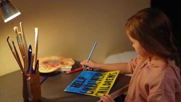 Rack Focus From Help Ukrainian Children Banner to Face of Stressed Sad Depressed Child Painting in