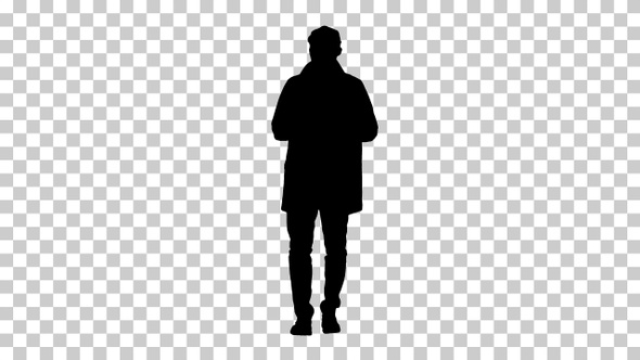 Silhouette Young man wearing trench coat talking to camera