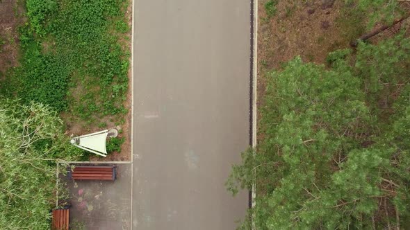 Aerial Dron Top Down View of Running Handsome Man in Morning Green Park