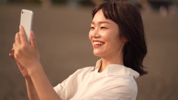 Woman taking a picture with a smartphone