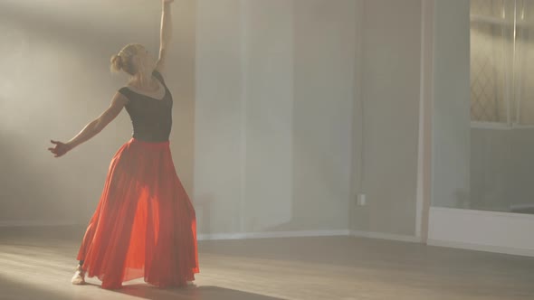 Wide Shot of Hardworking Slim Professional Ballerina in Scarlet Red Skirt Rehearsing Performance in