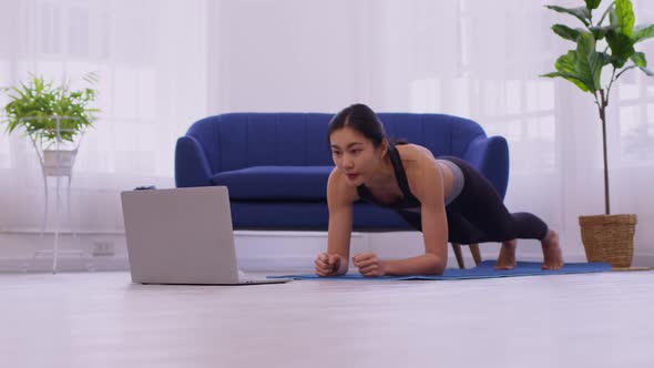 phalankasana, Plank posture, working out, wearing sportswear, Asian woman practicing yoga,