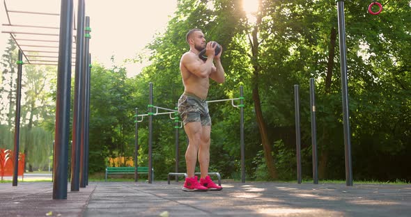 Muscular Man Doing Exercises Lifting Kettlebell Fitness