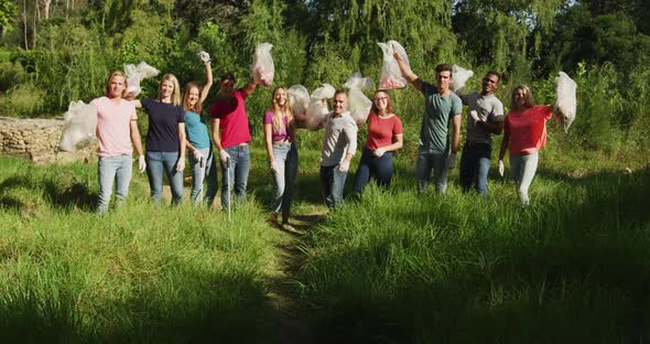 Mid adults volunteering during river clean-up day