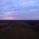 The Field Under the Dark Pink Sky in the Evening is Taken From a Drone - VideoHive Item for Sale