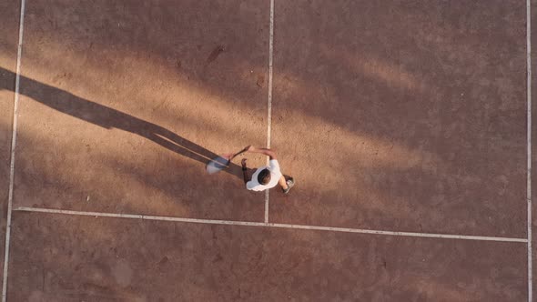 Drone Top Down Footage of Man Tennis Playerprace Game on Sandy Court