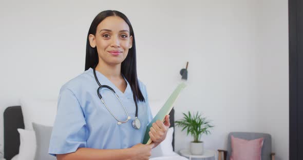 Animation of happy biracial female doctor looking at camera