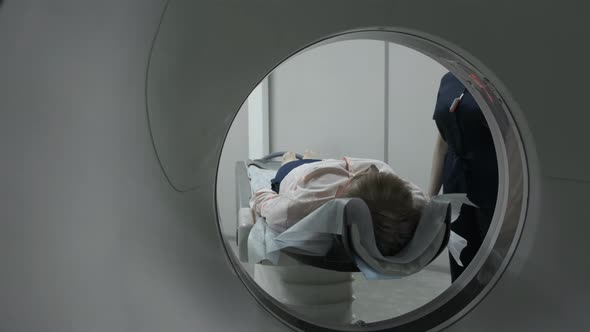 Female Patient On The Ct Or Mri Scanner Machine During X-Ray Process