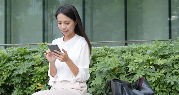 Business woman use of smart phone in city