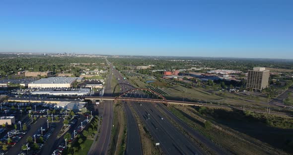 An evening pan over 6th Avenue, Lakewood Colorado.  We capture a light rail train as the Denver skyl