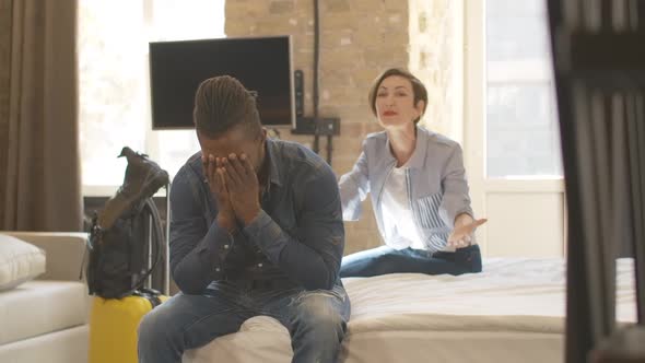 Angry Beautiful Caucasian Woman Yelling and Gesturing at the Background As Tired Bored African