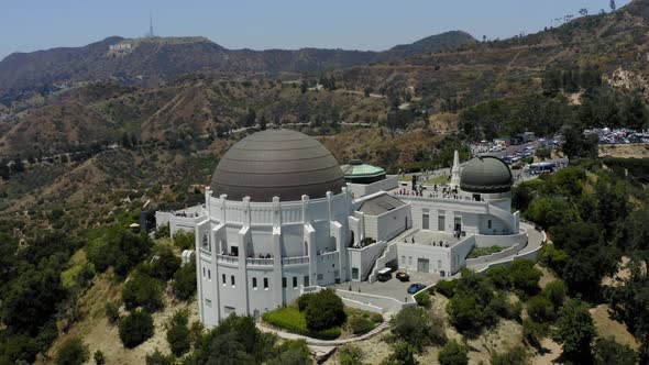 Aerial video orbiting the Griffith Observatory with the Hollywood sign in the background