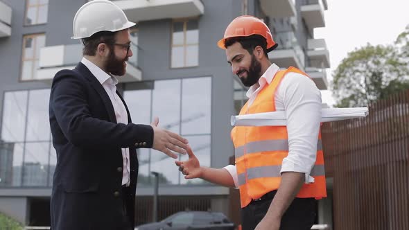 Construction Manager and Workers Shaking Hands on Construction Site. Professions, Construction