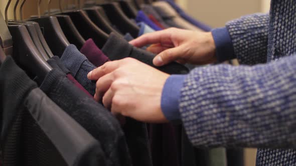 Man Choosing Wear at Shop