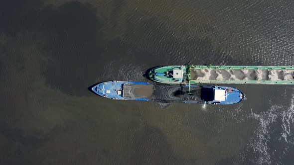 Dredging ship dredges off mud from river bottom to improve the fairway