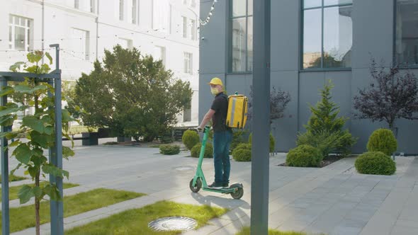 Delivery Man Wear Protective Mask and Ready to Send Delivering Food Bag in Front