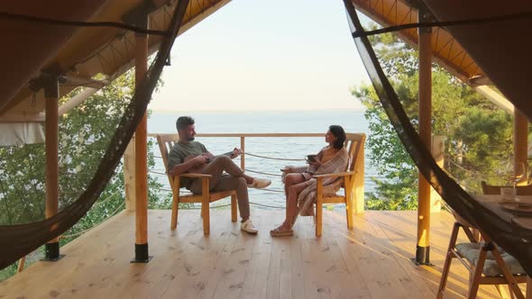 Young Couple Resting on Terrace by Lake