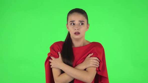 Portrait of Pretty Young Woman with Fear and Horror Looking Around. Green Screen