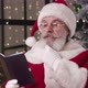 Thoughtful Charming Mature Man Dressed As Santa with Natural Gray Beard Reading Notes on Notepad - VideoHive Item for Sale