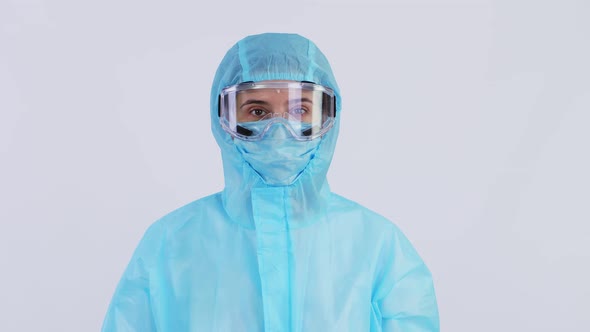 Portrait of Female Medical Worker, Doctor or Nurse, in Special Protective Uniform, Mask, Glasses