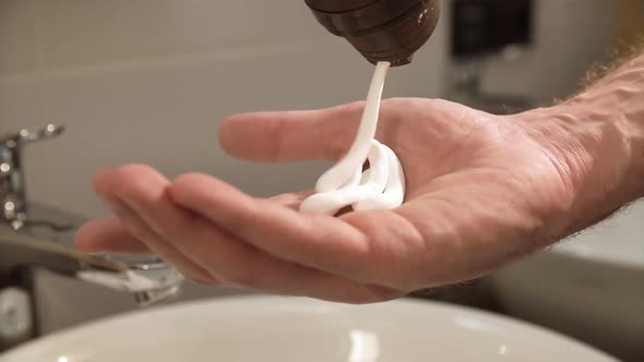 Shave Cream. Man Applying Shaving Foam On Hand Closeup