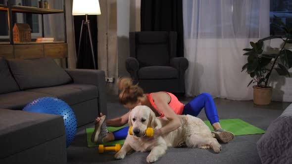 Fitness Female Stretching with Retriever Dog