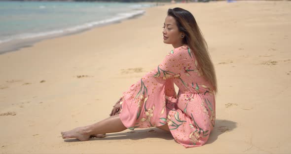 Barefoot Ethnic Woman Sitting on Beach