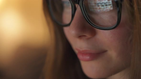 Woman in Glasses Looking on the Monitor and Surfing Internet