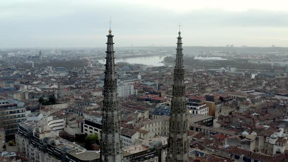 Bordeaux Cathedral of St. Andrew in France fly-through spires with golden crosses on top, Aerial dro